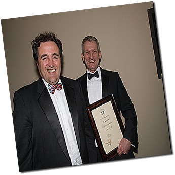 Bryan Hindle (right),  shows off Brick-Tie Preservation's training award at the PCA dinner in London
