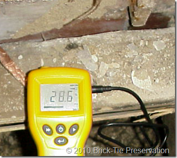 Electrical moisture meter reading 'fibre saturation' content in floor timbers in a hpouse in Leeds