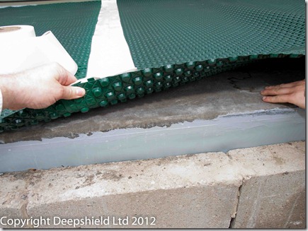 The edge of the deck with Vandex flextape overlapping the CDM below