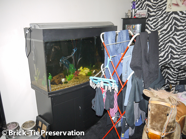 Image showing a clothes drying rack and a tropical fish tank in context of high humidity.